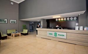 a lobby of a hotel with two people standing at a counter at Orbi Plaza 4 & New Boulevard in Batumi