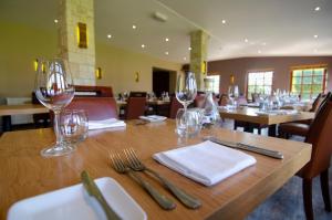 a table in a restaurant with wine glasses on it at Dornoch Castle Hotel in Dornoch