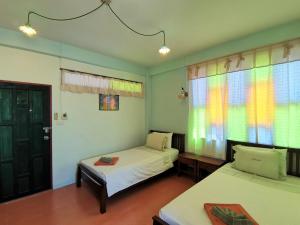 Cama o camas de una habitación en Baan Por Jai