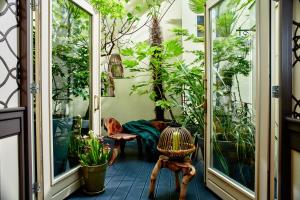 a balcony with plants and a glass door at Hotel Estheréa in Amsterdam