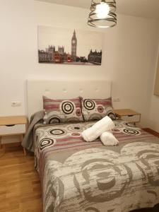 a bedroom with a bed with a comforter on it at Slow House Sarria in Sarria