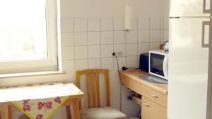 a small kitchen with a table and a microwave at FeWo Familia Wedemann in Bad Kreuznach
