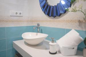 uma casa de banho com um lavatório branco num balcão em Apartamentos Coso de San Albin em Mérida
