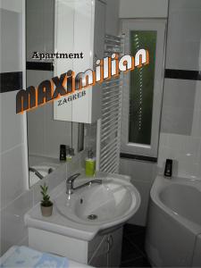 a white bathroom with a sink and a toilet at Apartment Maximilian-free parking!!! in Zagreb