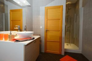 a bathroom with a sink and a shower at Le Moulin d'Harcy in Lonny