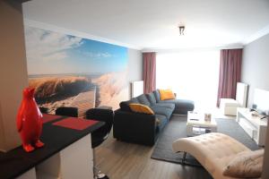 a living room with a large painting on the wall at Knokke luxury appartement in Knokke-Heist
