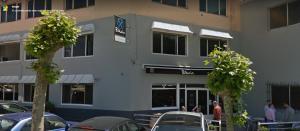 a building with cars parked in a parking lot at PENSIÓN B2bIKAIN HSS00895 in Oiartzun