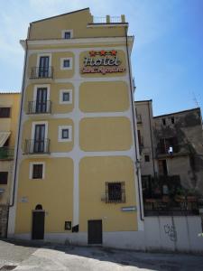 un gran edificio amarillo con un cartel de hotel en Hotel Sant'Agostino, en Paola