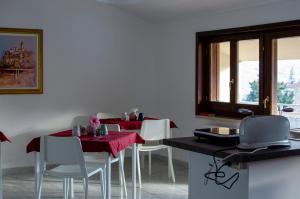 a dining room with two tables and white chairs at BnB acasaconme in Lucito