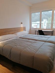 1 cama grande en un dormitorio con ventana en PENSIÓN B2bIKAIN HSS00895 en Oiartzun