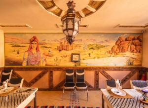 a large painting on the wall of a restaurant at Riad Rihana Dades in Boumalne