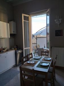 a kitchen with a table and chairs and a kitchen with a table and a kitchen at da Irma in terrazza in Crema +33 photos