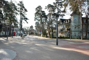 a street with a blue house and a building at Jomas 76 in Jūrmala