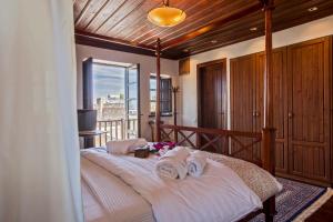 a bedroom with a large bed with towels on it at Medieval Dreams Villa in Rhodes Town