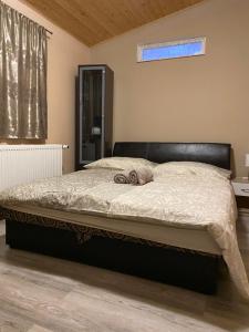 A bed or beds in a room at Virág Vendégház