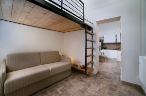 a living room with a couch and a staircase at Sui Tetti, Caressa de mä in Bordighera