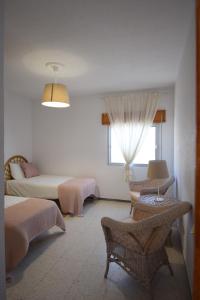 A bed or beds in a room at Las Eras - La casa frente al mar