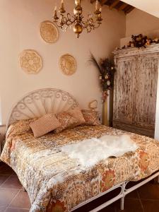 a bedroom with a bed and a chandelier at Alloggio turistico S.Pellegrino 45 in Viterbo