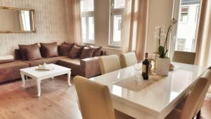 a living room with a white table and a couch at Appartements am Bachhaus in Eisenach