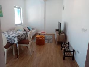 a living room with a table and a couch at FLAMANITA APARTMENTS in Skopje