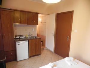 a small kitchen with a sink and a stove at Pension Niki in Kalymnos
