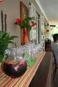 a table with glasses and a vase on it at Firenze in Kloof