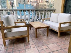 two chairs and a coffee table on a balcony at Hotel Scherman in New York