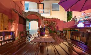 a table in a restaurant with a bottle of wine on it at Mascot Garden Rooms in Rhodes Town