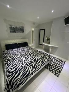 uma cama com estampa de zebra num quarto branco com em B & Baichin em Staranzano
