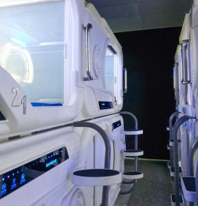 a row of stools in a hospital room at Bangau - Short Term Rest Area Capsule Hotel in Sepang