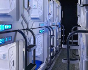 a row of white refrigerators lined up in a row at Bangau - Short Term Rest Area Capsule Hotel in Sepang