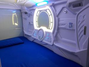 an inside view of a room in an astronaut capsule at Bangau - Short Term Rest Area Capsule Hotel in Sepang