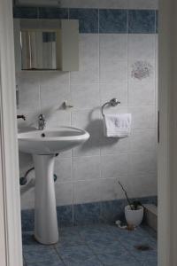 a bathroom with a white sink and a mirror at Armenaki Apartments in Sampatiki +56 photos