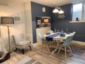 a dining room with a table and chairs at Rosie’s on the Crescent in Filey