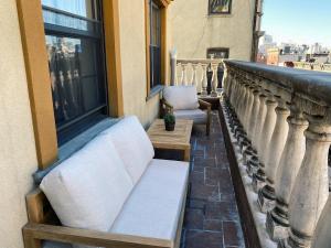 a balcony with a bench and a window at Hotel Scherman in New York