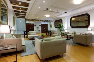 a large living room with couches and tables at Hotel Príncipe de Asturias in Gijón