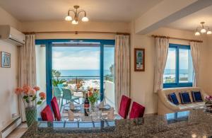 a living room with a table and a view of the ocean at Penthouse direkt am Meer in Polis Chrysochous