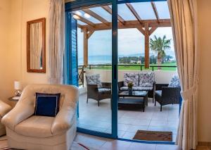 a living room with a couch and chairs at Penthouse direkt am Meer in Polis Chrysochous