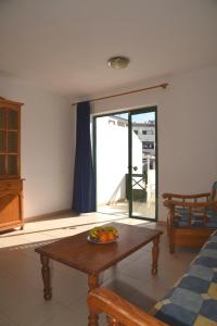 a room with a table with a bowl of fruit on it at Sunny Silencio Park in Arona