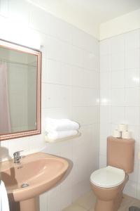 a bathroom with a sink and a toilet and a mirror at Sunny Silencio Park in Arona