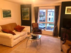 a living room with a couch and a table at Sea Breeze in Bangor