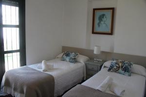Posteľ alebo postele v izbe v ubytovaní Apartamentos Peregrinos