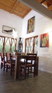 a dining room with a wooden table and chairs at Alternative Space B & B in Swakopmund