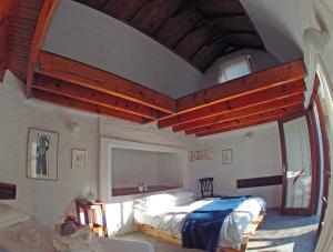 a bedroom with a large bed and a large window at Alternative Space B & B in Swakopmund