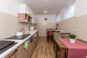 a kitchen and dining room with a table in it at Willa Biały Domek in Ustroń
