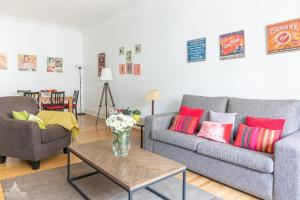 a living room with two couches and a table at Casa da Avenida Lisboa in Lisbon