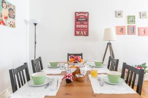 a dining room table with a bowl of fruit on it at Casa da Avenida Lisboa in Lisbon
