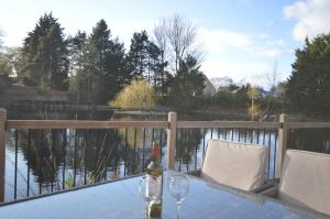a table with a bottle of wine and two glasses at Lakeside Old Hunstanton in Hunstanton