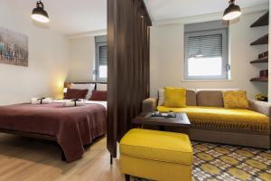 a living room with a bed and a couch and a bed at Apartment Story,Nikole Cupica Beograd in Belgrade