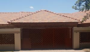 a house with a fence and a tile roof at Vaticious in Secunda